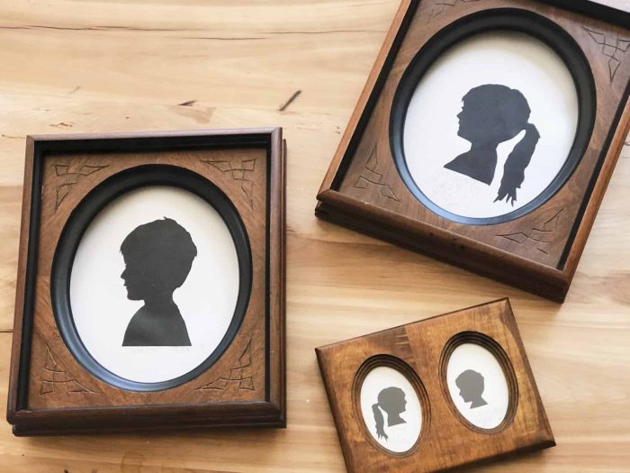 Wooden frames with photos of black silhouettes in them. 