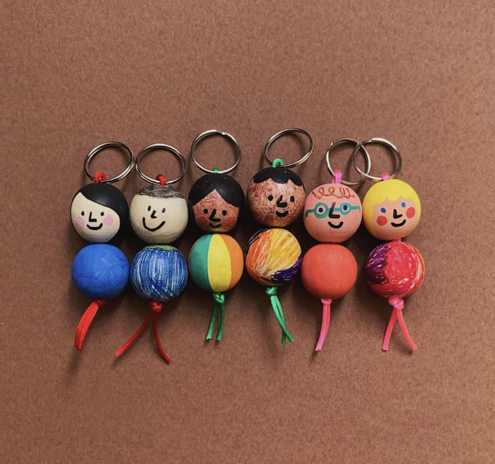 Homemade keychains decorated as little people. 