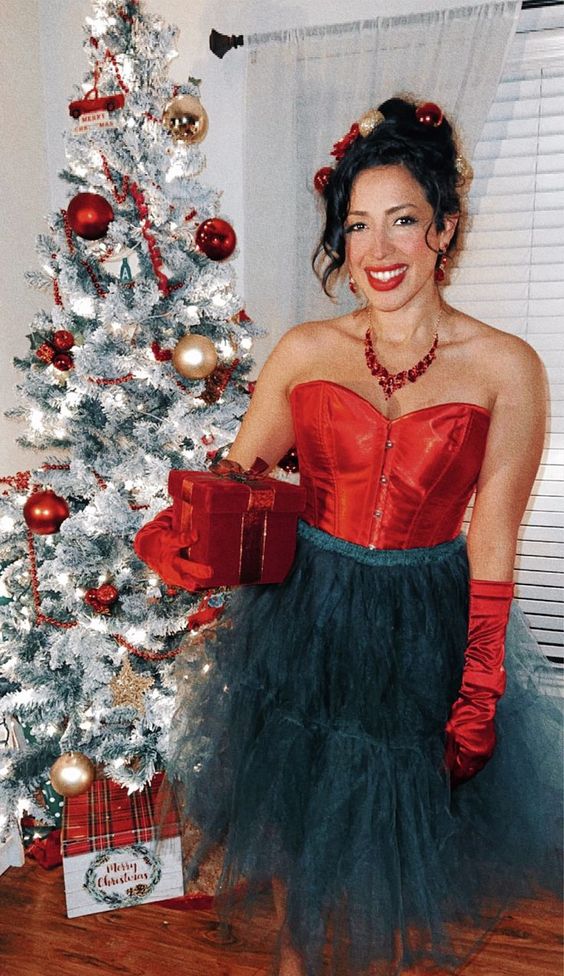 Woman dressed as Martha May Whovier in front of a Christmas tree.