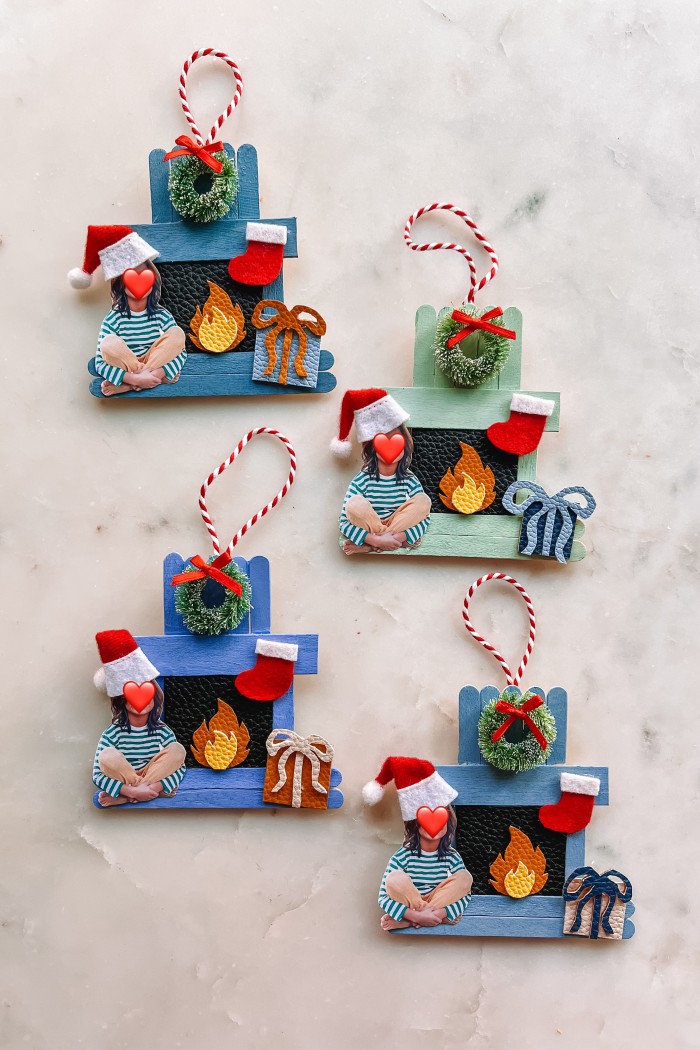 four popsicle stick fireplace ornaments on marble
