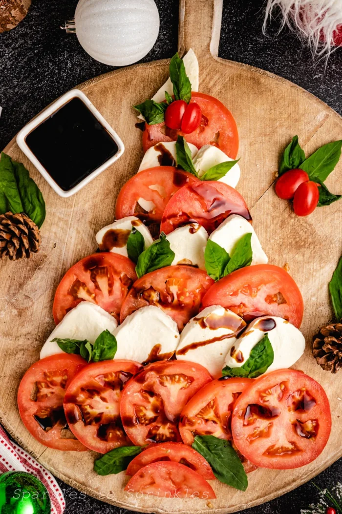 Tomatoes and mozzarella cheese in the form of a tree on a wooden board. 