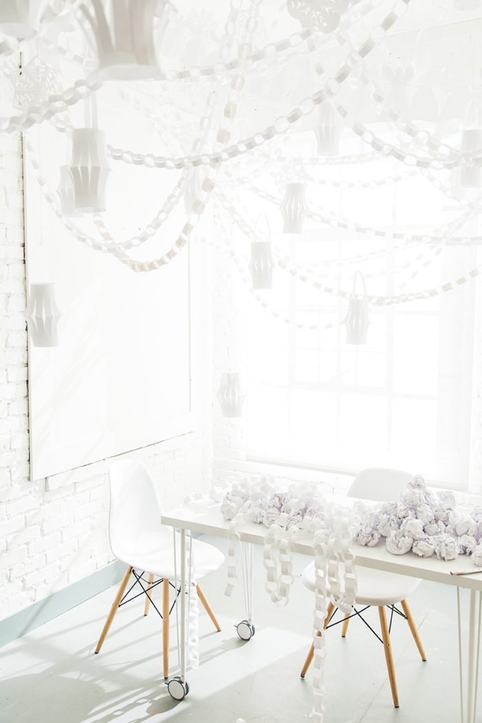 Room decorated with white decorations made out of paper. 