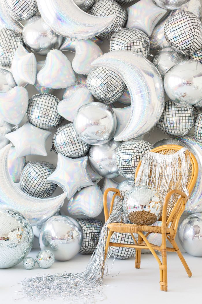 Silver balloons in the shapes of moons, stars, hearts and disco balls. 