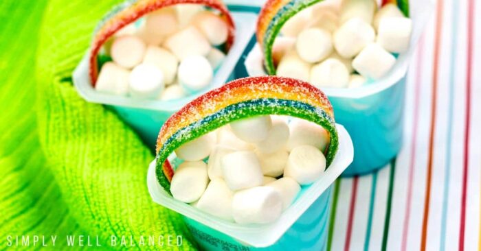Pudding cups with marshmallows and rainbow gummy on top. 