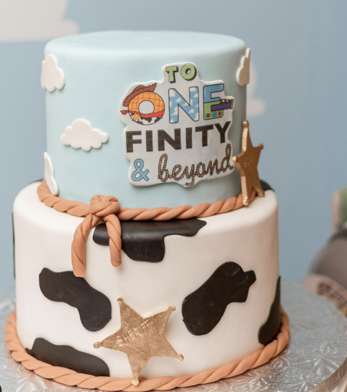 Toy story cake with the words "to one-finity and beyond" on it. 