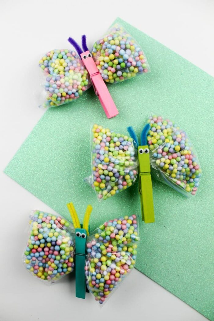 Bags of candies clipped together with a clothes pin to look like a butterfly. 