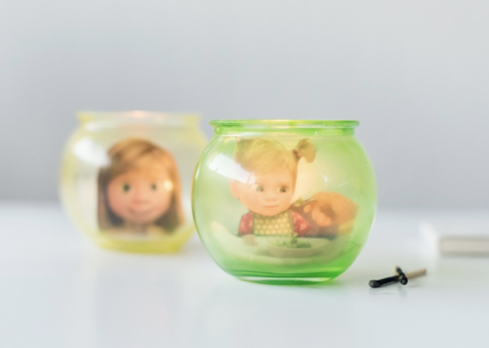 Glass candle holders with photos of Inside Out characters in them. 