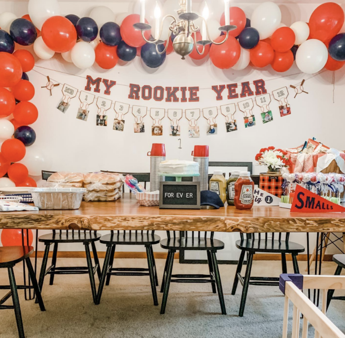 Sports themed birthday party with a banner saying "my rookie year". 