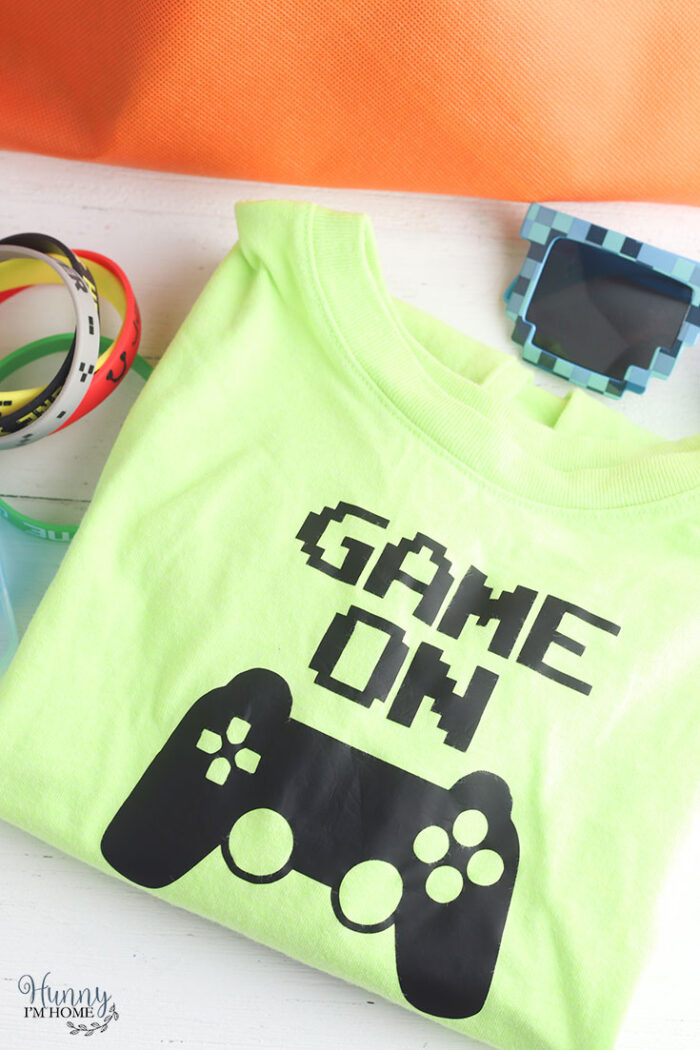 Tshirt with the words "game on" and a video game controller. 