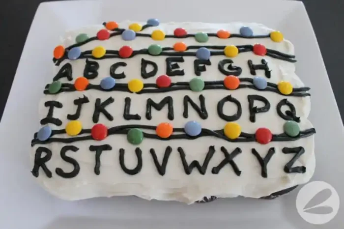 Cake with alphabet and colored candies on it. 