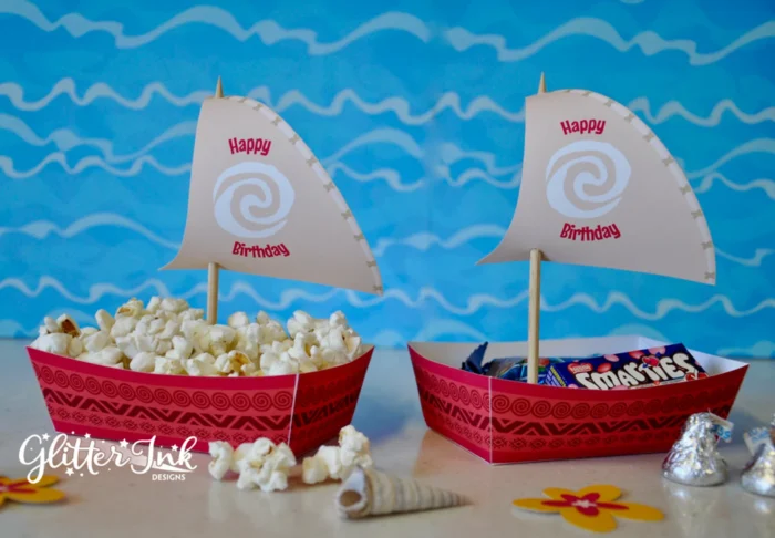 Two cardboard Moana-themed snack boats. 