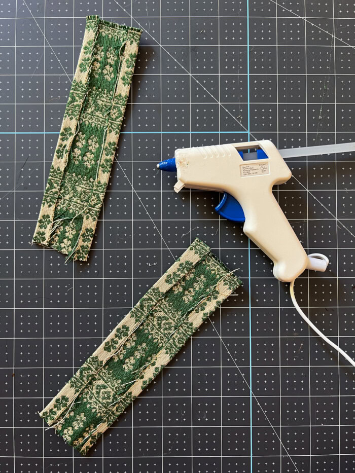 small pieces of fabric next to glue gun