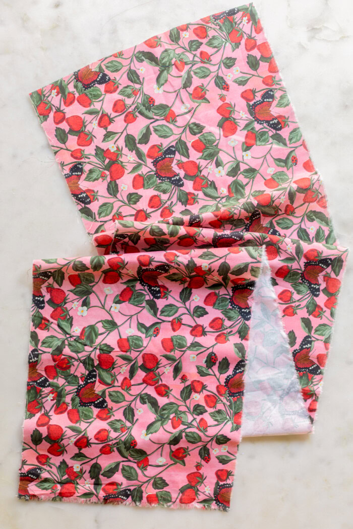 long piece of pink floral and strawberry fabric
