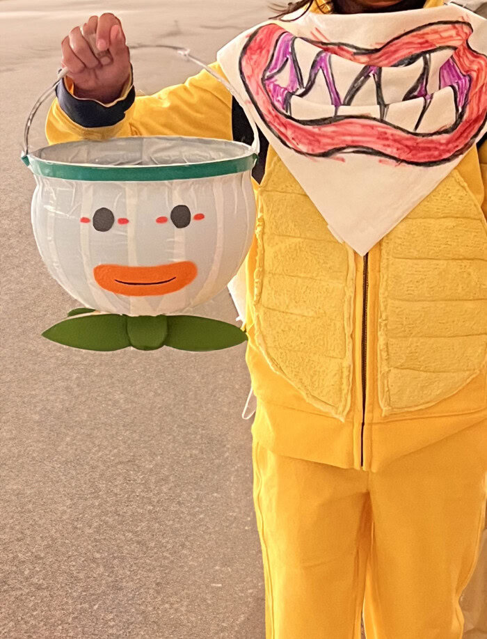 Child holding Clown Car treat bucket