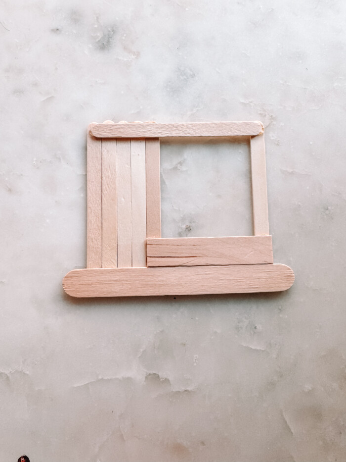 popsicle sticks forming a store on marble