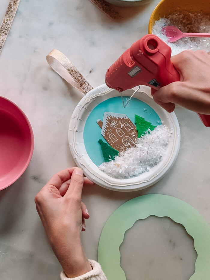 putting hot glue on paper plate