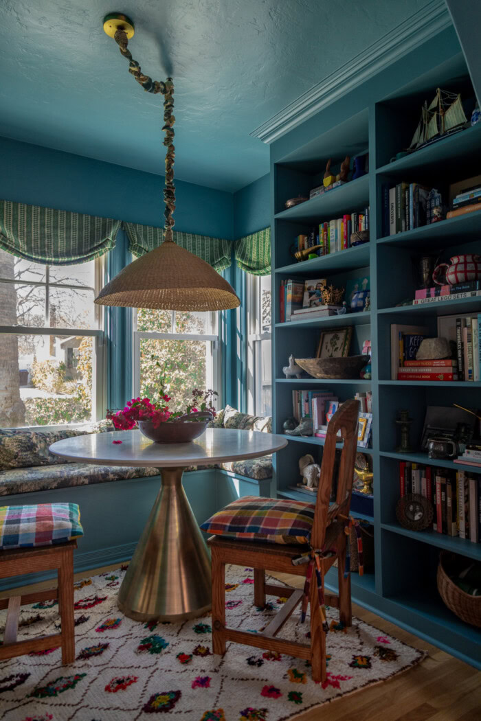 colorful dining room with blue walls and plaid cushions