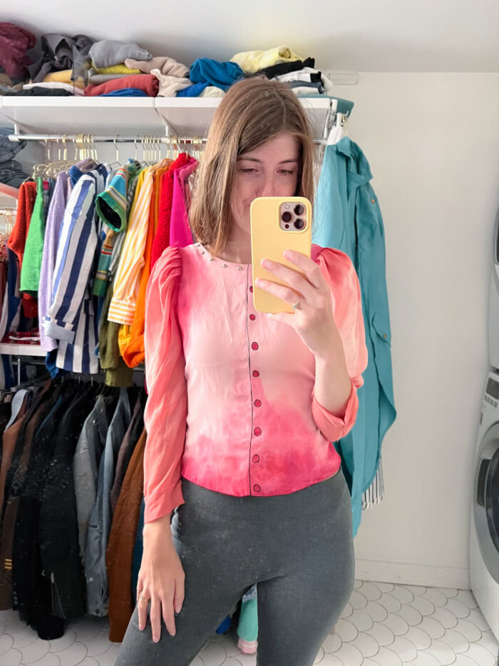 woman taking photo of pink painted shirt